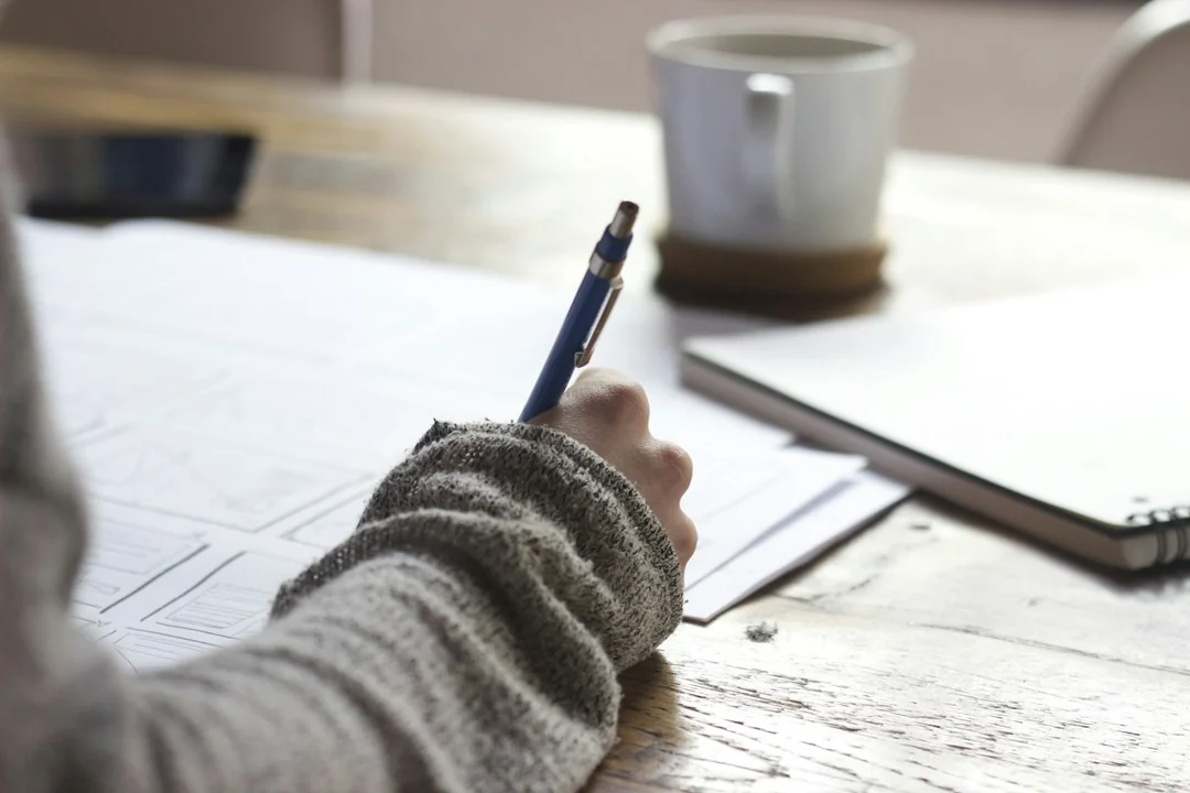 A person writing study notes